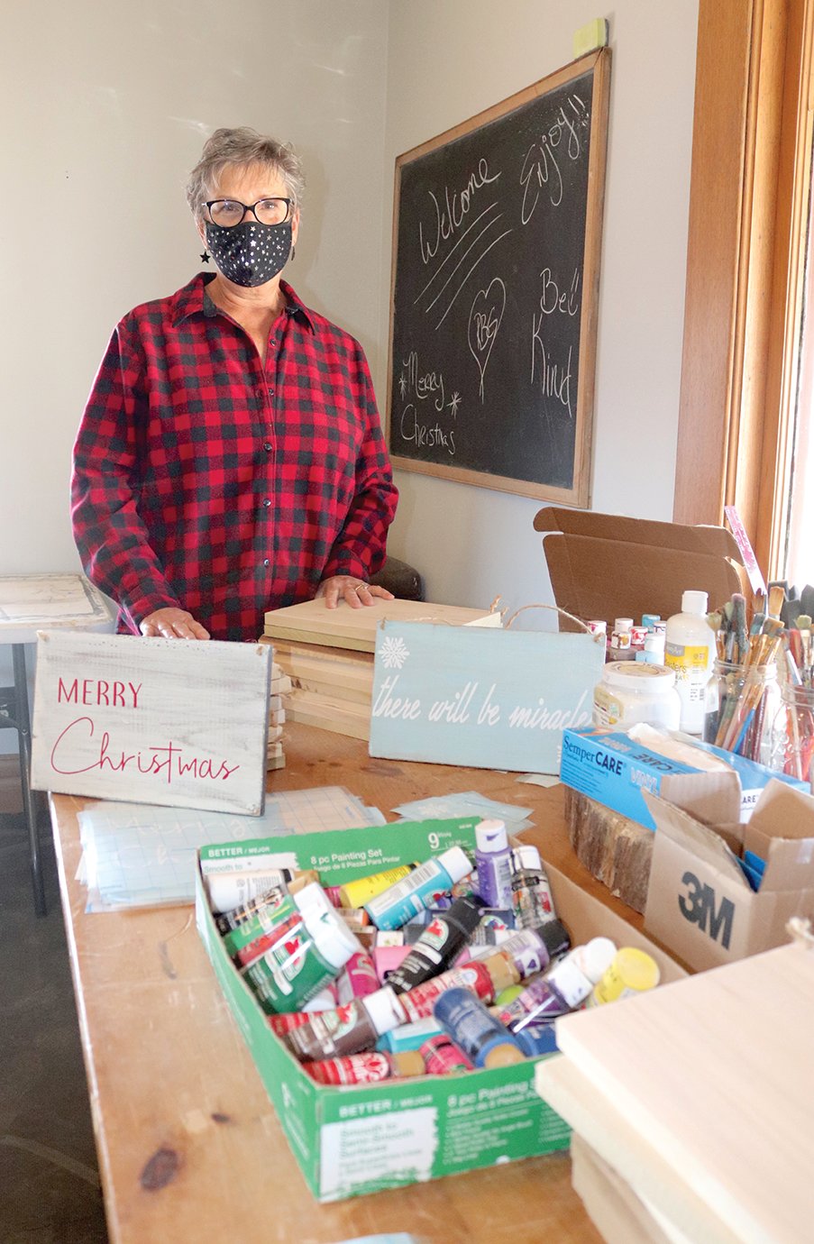 Terri Trinkle, class instructor at Reclaimed by Grace, shows off a bit of her classroom Friday during a holiday open house event for businesses downtown.